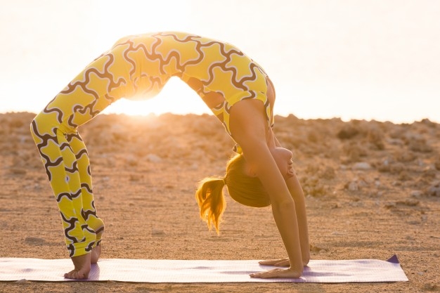 yoga praxis frau macht brücke pose | yoga praxis